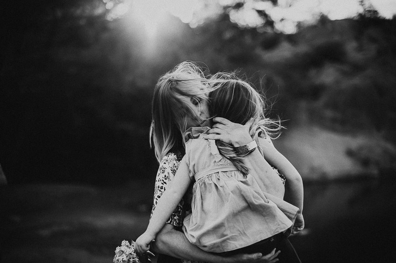 Family Photography, black and white image of mom holding and hugging daughter