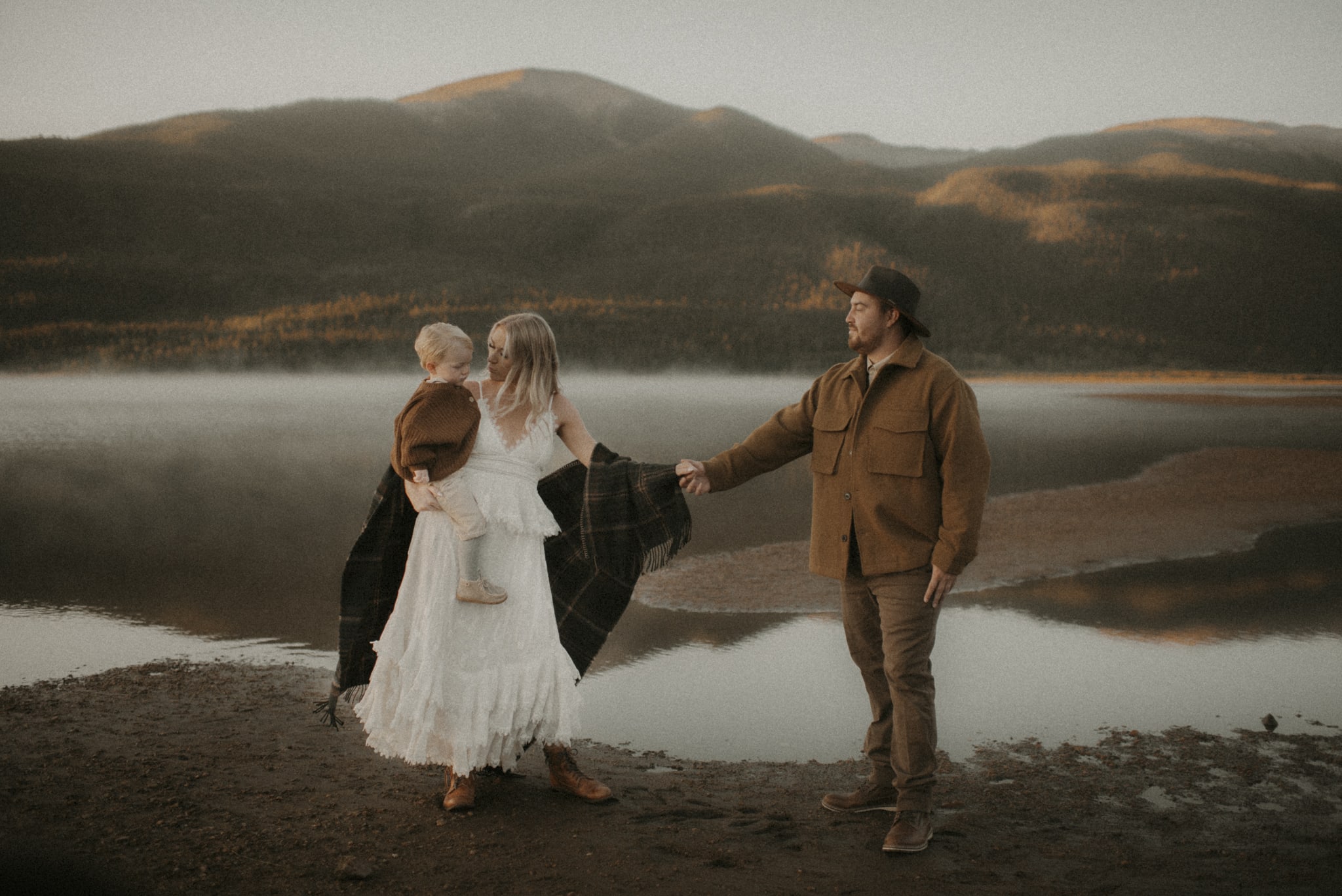 Family Photography, Family of three standing next to a lake, husband and wife are holding hands